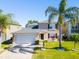 Charming two-story home features a well-manicured lawn, lovely landscaping, and an attached two-car garage at 543 Flower Fields Ln, Orlando, FL 32824