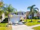 Charming two-story home boasting a well-manicured lawn and an attached two-car garage at 543 Flower Fields Ln, Orlando, FL 32824