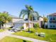 Charming two-story home features a well-manicured lawn, lovely landscaping, and an attached two-car garage at 543 Flower Fields Ln, Orlando, FL 32824