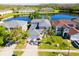 Aerial view of home with lake view, green lawn and palm trees at 543 Flower Fields Ln, Orlando, FL 32824