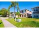 Home exterior featuring an attached garage, landscaped front yard and mature plants at 543 Flower Fields Ln, Orlando, FL 32824