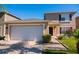 Inviting exterior showcasing a two-car garage, landscaped yard, and cozy covered front entrance at 543 Flower Fields Ln, Orlando, FL 32824