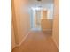 Carpeted hallway with neutral walls, white trim, and multiple doorways at 543 Flower Fields Ln, Orlando, FL 32824