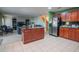Kitchen with island, stainless steel refrigerator, and open to living space at 543 Flower Fields Ln, Orlando, FL 32824