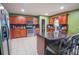 Large kitchen with granite countertops, stainless steel appliances, and an island with seating at 543 Flower Fields Ln, Orlando, FL 32824
