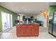 Kitchen with island, stainless steel refrigerator, and open to living space at 543 Flower Fields Ln, Orlando, FL 32824