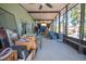 Spacious screened porch with ceiling fans provides ample outdoor living space with furniture at 543 Flower Fields Ln, Orlando, FL 32824