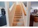 Carpeted staircase leading to the upper level with a wooden handrail at 543 Flower Fields Ln, Orlando, FL 32824