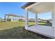 Covered back patio overlooking the large backyard and neighboring homes at 5717 Haystack Dr, St Cloud, FL 34771