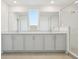 Modern bathroom featuring double vanity, granite countertops, and glass-enclosed shower at 5717 Haystack Dr, St Cloud, FL 34771