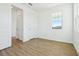 Bedroom with bright window and wood-look flooring offering lots of natural light at 5717 Haystack Dr, St Cloud, FL 34771