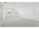 Bright bedroom featuring neutral carpet, fresh white walls, and natural light from a window at 5717 Haystack Dr, St Cloud, FL 34771