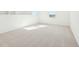 Bright bonus room featuring neutral carpeting and natural light from large windows at 5717 Haystack Dr, St Cloud, FL 34771