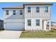 Charming two-story home with a well-manicured lawn and attached two-car garage at 5717 Haystack Dr, St Cloud, FL 34771