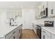 Modern kitchen featuring a large island, stainless appliances, and gray cabinets at 5717 Haystack Dr, St Cloud, FL 34771