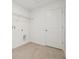 Well-lit laundry room with tile floors, utility connections, and wire shelving at 5717 Haystack Dr, St Cloud, FL 34771