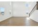 Bright and expansive living room with tile floors, high ceilings, and open staircase at 5717 Haystack Dr, St Cloud, FL 34771