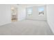Spacious main bedroom with neutral carpet, ample natural light, and ensuite bathroom at 5717 Haystack Dr, St Cloud, FL 34771