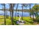 Scenic view of lake with boat dock, fire pit and backyard at 5824 N Dean Rd, Orlando, FL 32817