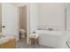 Elegant bathroom showcasing a freestanding tub, marble accents, and a contemporary toilet at 5824 N Dean Rd, Orlando, FL 32817
