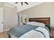 Bedroom with wood-look floors, ceiling fan, large windows and traditional wooden headboard at 5824 N Dean Rd, Orlando, FL 32817