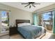 Inviting bedroom with wood-look floors, ceiling fan and large windows with water view at 5824 N Dean Rd, Orlando, FL 32817