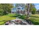 Modern lake house with screened porch, glass windows, firepit area, and a serene outdoor setting at 5824 N Dean Rd, Orlando, FL 32817