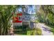 Brightly painted lakeside home with mature landscaping at 5824 N Dean Rd, Orlando, FL 32817