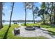 Lakeside fire pit area with paver patio and seating, perfect for outdoor entertaining and relaxing at 5824 N Dean Rd, Orlando, FL 32817
