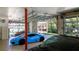 Luxury garage with glass doors showcasing a blue Lamborghini and grey car with lake view at 5824 N Dean Rd, Orlando, FL 32817