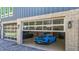 Three car garage showcasing luxury cars and glass doors leading to the exterior and interior of home at 5824 N Dean Rd, Orlando, FL 32817