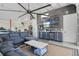 Finished garage area with a large TV, wet bar, comfortable seating area, and industrial ceiling fan at 5824 N Dean Rd, Orlando, FL 32817