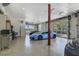 Showcase garage with polished floors, glass doors, pool table, and luxury cars at 5824 N Dean Rd, Orlando, FL 32817