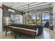 Converted garage space with a stylish lounge area, lake views, TV, and a shuffleboard table at 5824 N Dean Rd, Orlando, FL 32817