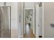 Hallway with modern wood floors, white trim, doors and cabinetry, and stainless steel refrigerator at 5824 N Dean Rd, Orlando, FL 32817