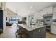 Open kitchen with a central island, seating, stainless steel appliances, and bright natural light at 5824 N Dean Rd, Orlando, FL 32817