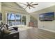 Bright living room featuring a comfortable sofa, lake views, and a modern ceiling fan at 5824 N Dean Rd, Orlando, FL 32817