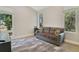 Bright living room featuring large windows, contemporary furniture, and a geometric rug at 5824 N Dean Rd, Orlando, FL 32817