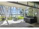 Relaxing screened patio with hot tub overlooking manicured backyard and picturesque lake at 5824 N Dean Rd, Orlando, FL 32817