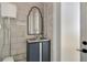 Modern powder room with sleek vanity, decorative mirror, and industrial-chic block walls at 5824 N Dean Rd, Orlando, FL 32817