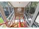 Unique glass-enclosed staircase with red railings and wooden steps, offering bright, natural light at 5824 N Dean Rd, Orlando, FL 32817