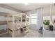 Nautical-themed bedroom featuring a custom-built bunk bed with life preserver accents and striped wall at 7006 Rosy Sky Ave, Orlando, FL 32829