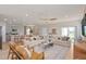 Spacious open-plan living room and kitchen with modern decor and ample natural light, perfect for entertaining at 7006 Rosy Sky Ave, Orlando, FL 32829