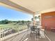 Spacious balcony with comfortable seating overlooking the lush green golf course and palm tree views at 7593 Gathering Dr # 203, Reunion, FL 34747
