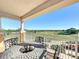 Enjoy stunning golf course views from this private balcony with outdoor seating, perfect for relaxation and entertaining at 7593 Gathering Dr # 203, Reunion, FL 34747