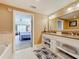 Bright bathroom features a double sink vanity, granite counters, a walk-in shower, and a tub at 7593 Gathering Dr # 203, Reunion, FL 34747