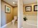Bathroom features a toilet and artistic decor at 7593 Gathering Dr # 203, Reunion, FL 34747
