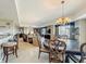 Spacious dining room with a chandelier above, and open views to living room at 7593 Gathering Dr # 203, Reunion, FL 34747