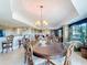 Elegant dining room with a chandelier, connecting kitchen, dining, and living areas at 7593 Gathering Dr # 203, Reunion, FL 34747