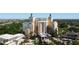 Stunning exterior view of a luxury hotel featuring towers, palm trees, and resort-style amenities at 7593 Gathering Dr # 203, Reunion, FL 34747